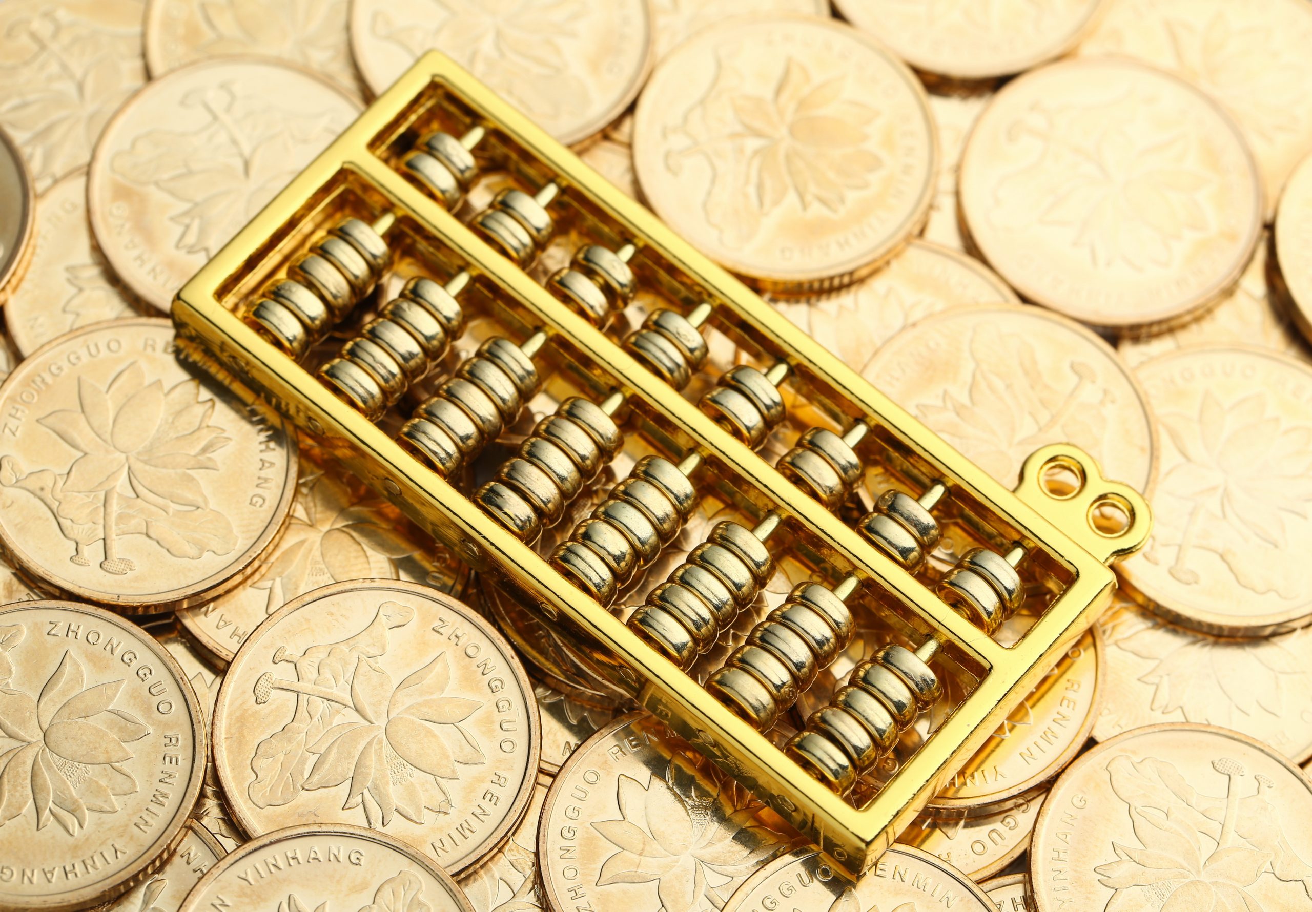 Golden Abacus with Chinese rmb gold coins as background